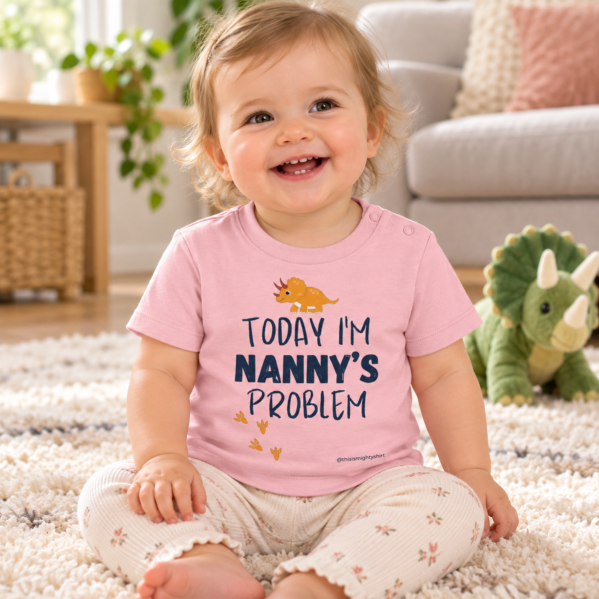 Baby wearing Cotton Pink Today I'm Nanny's Problem dinosaur T-shirt