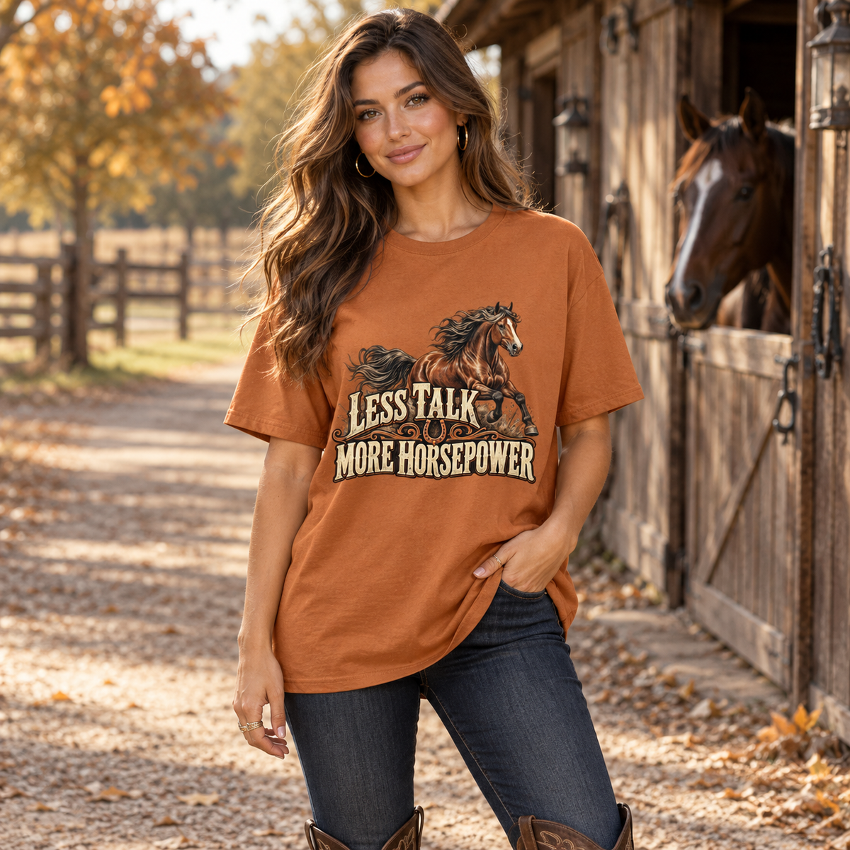Less Talk More Horsepower Women's Country T-Shirt in Fan Texas Orange, worn in a country lifestyle setting