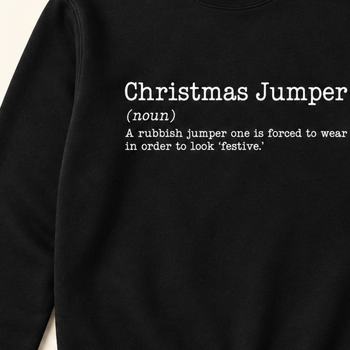 Close-up of white Christmas Jumper dictionary definition print on black sweatshirt
