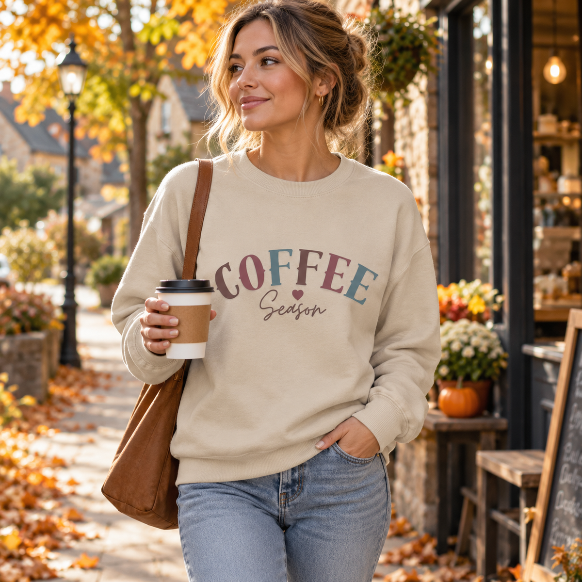 Woman wearing Natural Stone Coffee Season sweatshirt outdoors