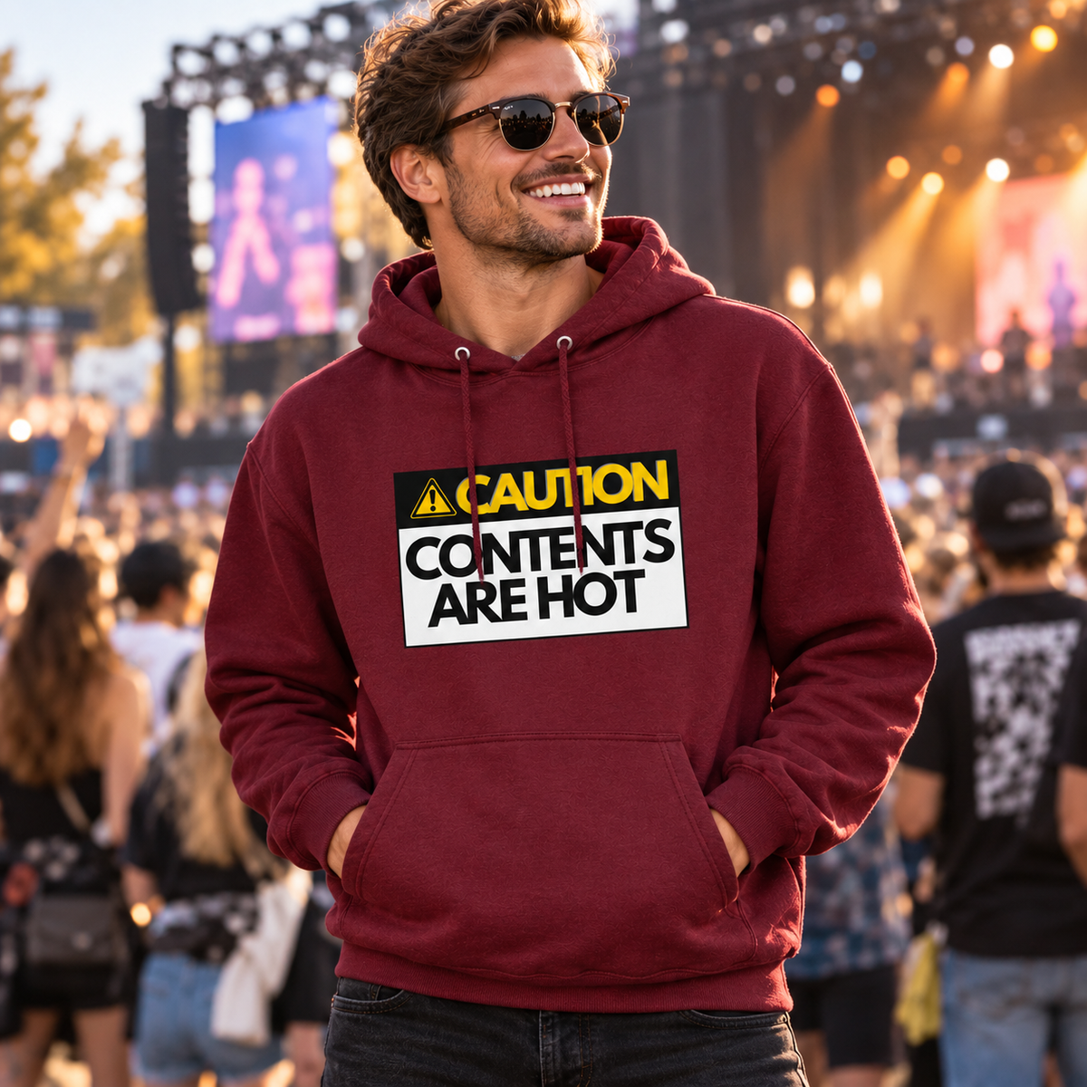 Man wearing Burgundy Hot Contents hoodie at a music festival