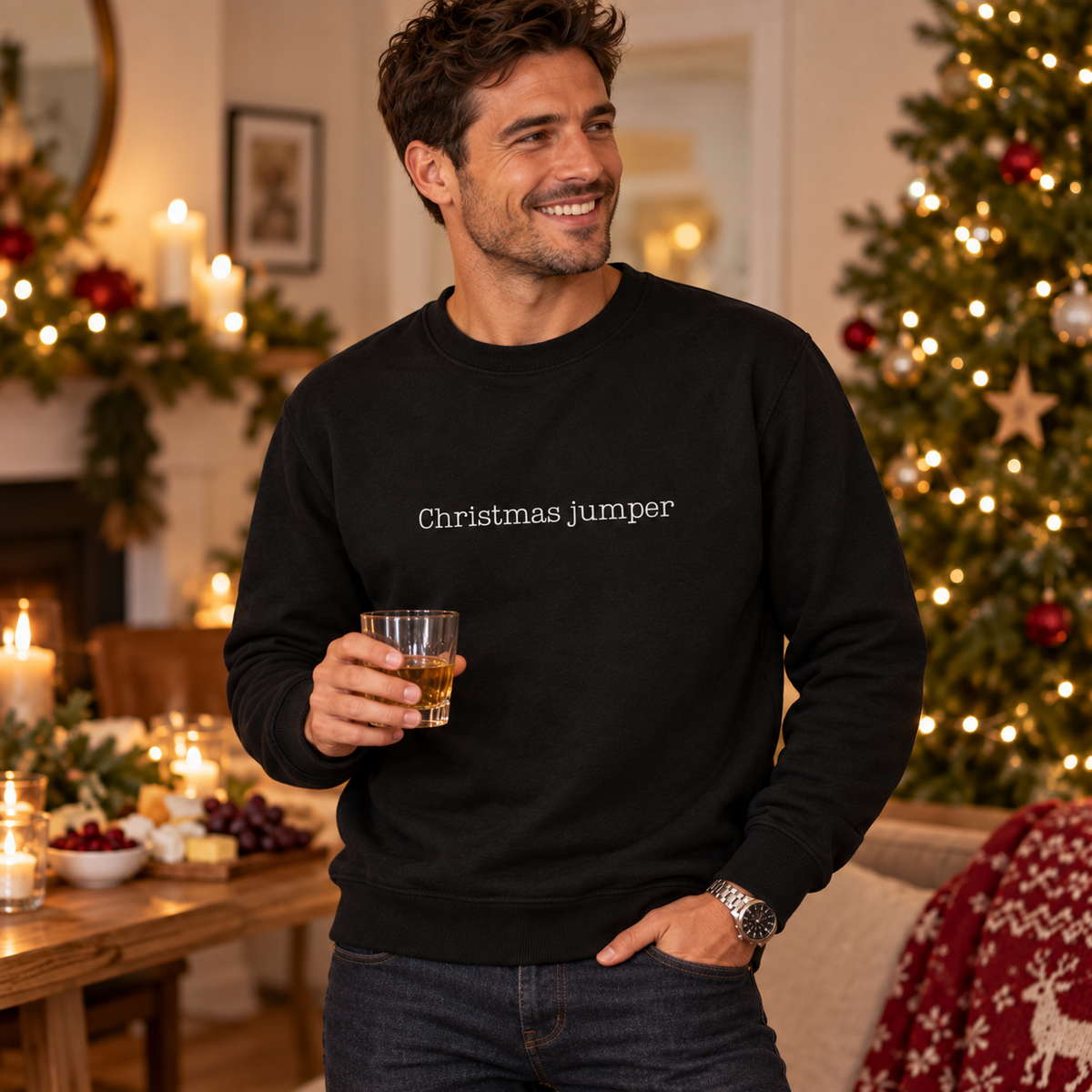 Man wearing a black Christmas jumper slogan sweatshirt in a festive lounge