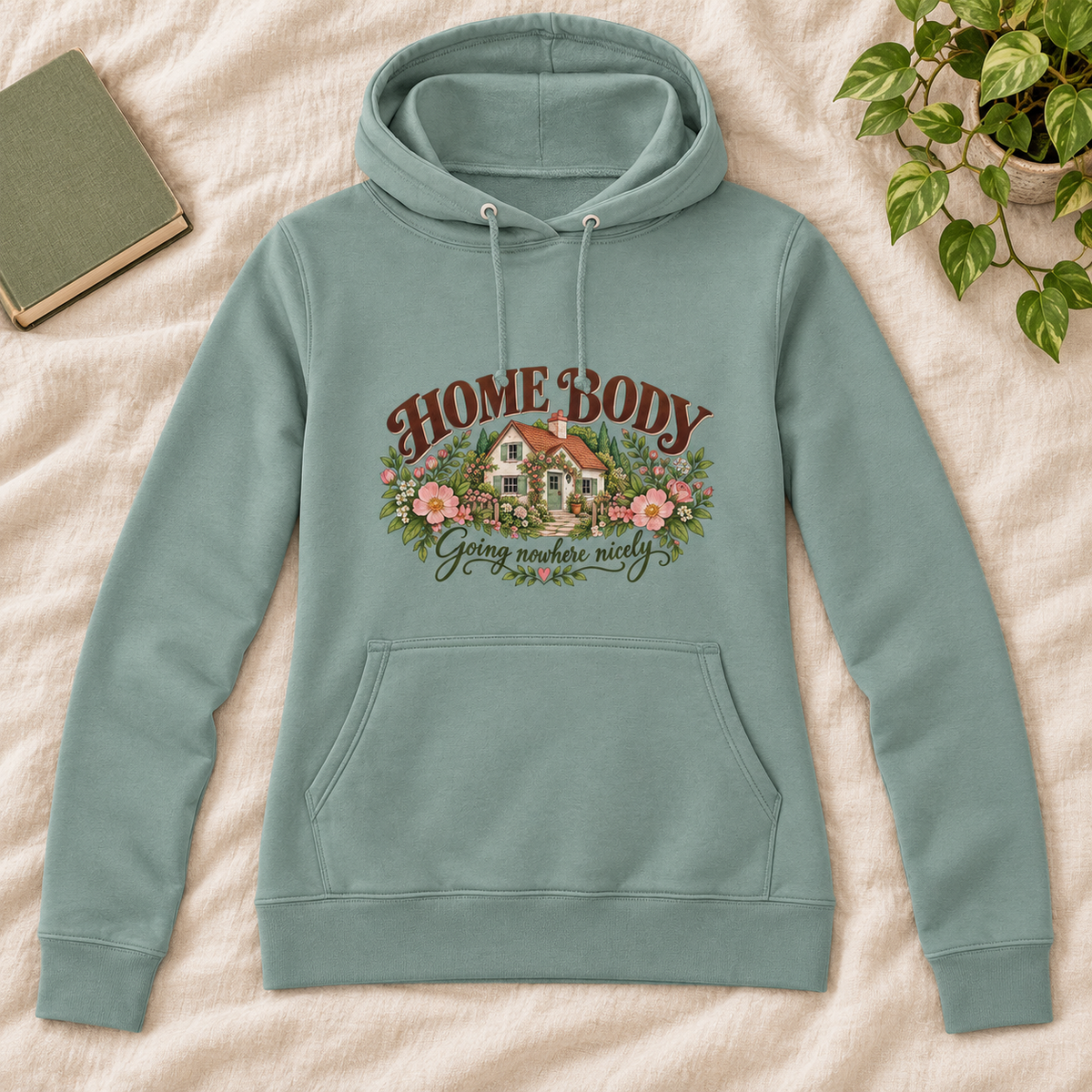 Home Body Going Nowhere Nicely Women’s Hoodie in Dusty Green, front artwork flat lay