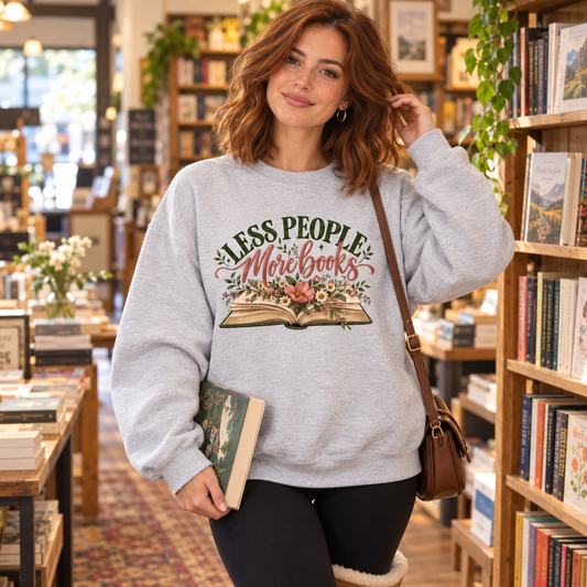 Heather Grey Less People More Books women’s sweatshirt styled in a bookshop