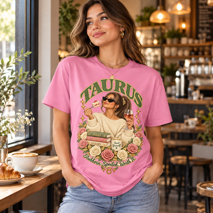 Taurus Stubborn Spoiled Worth It Women's T-Shirt – Light in Fan Candy Pink, model inside a stylish warm independent cafe beside a window