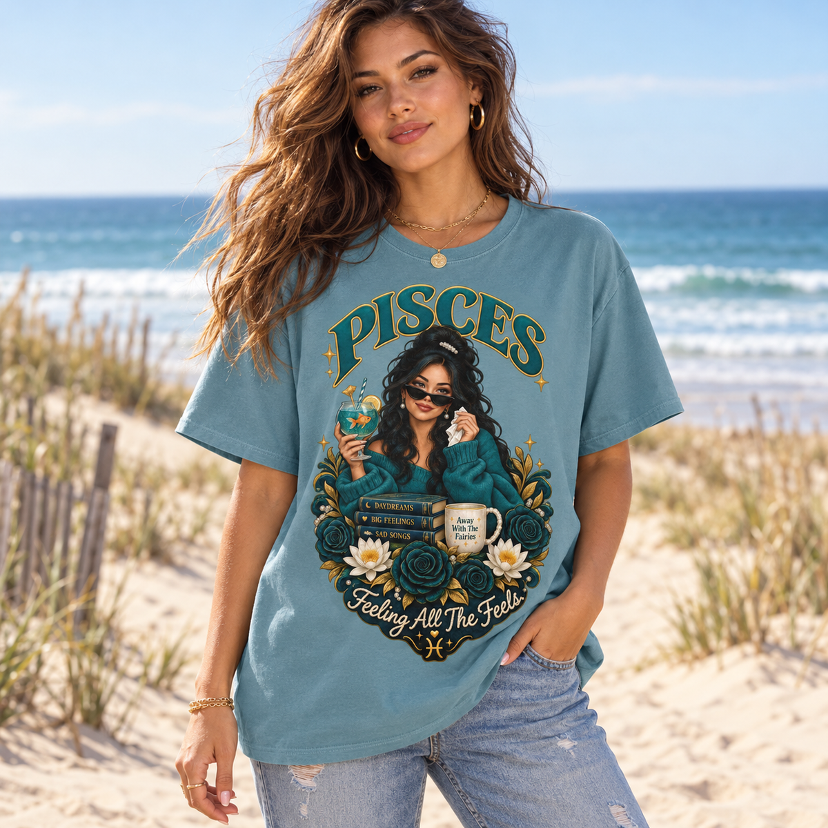 Pisces Feeling All the Feels Women's T-Shirt – Dark in Stone Blue, model at a sandy beach with sea and dunes