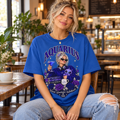 Aquarius Weird Wonderful Unbothered Women's T-Shirt – Dark Colours, model wearing the original design in a cosy stylish coffee shop indoors.
