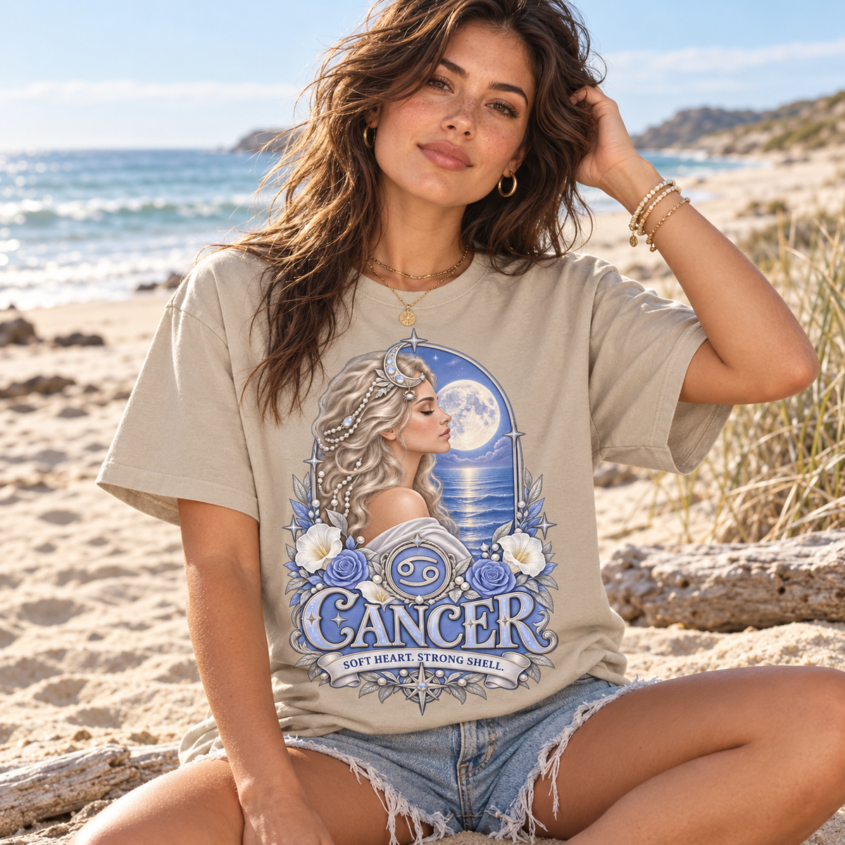 Cancer Soft Heart Strong Shell Women's T-Shirt – Light in Sand, model on a beautiful sandy beach with sea and dunes