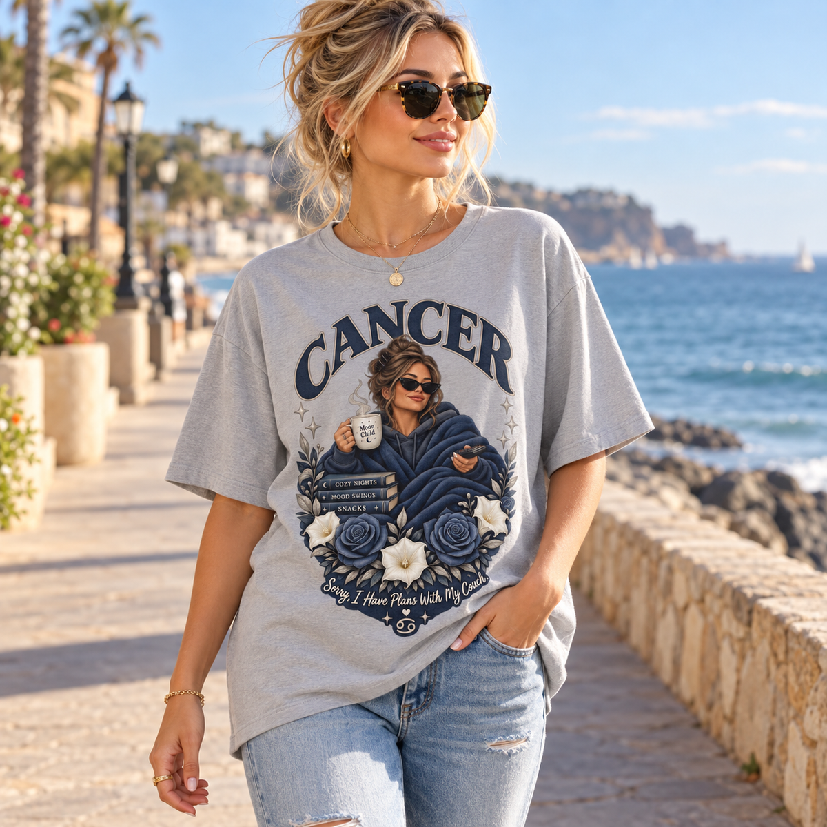 Cancer Plans with My Couch Women's T-Shirt – Dark in Sports Grey, model walking on a seaside promenade with soft afternoon light