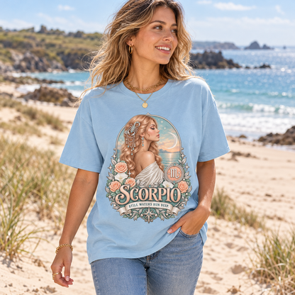 Scorpio Still Waters Run Deep Women's T-Shirt – Light in Light Blue, model walking on a sandy Channel Islands beach with dunes and sea