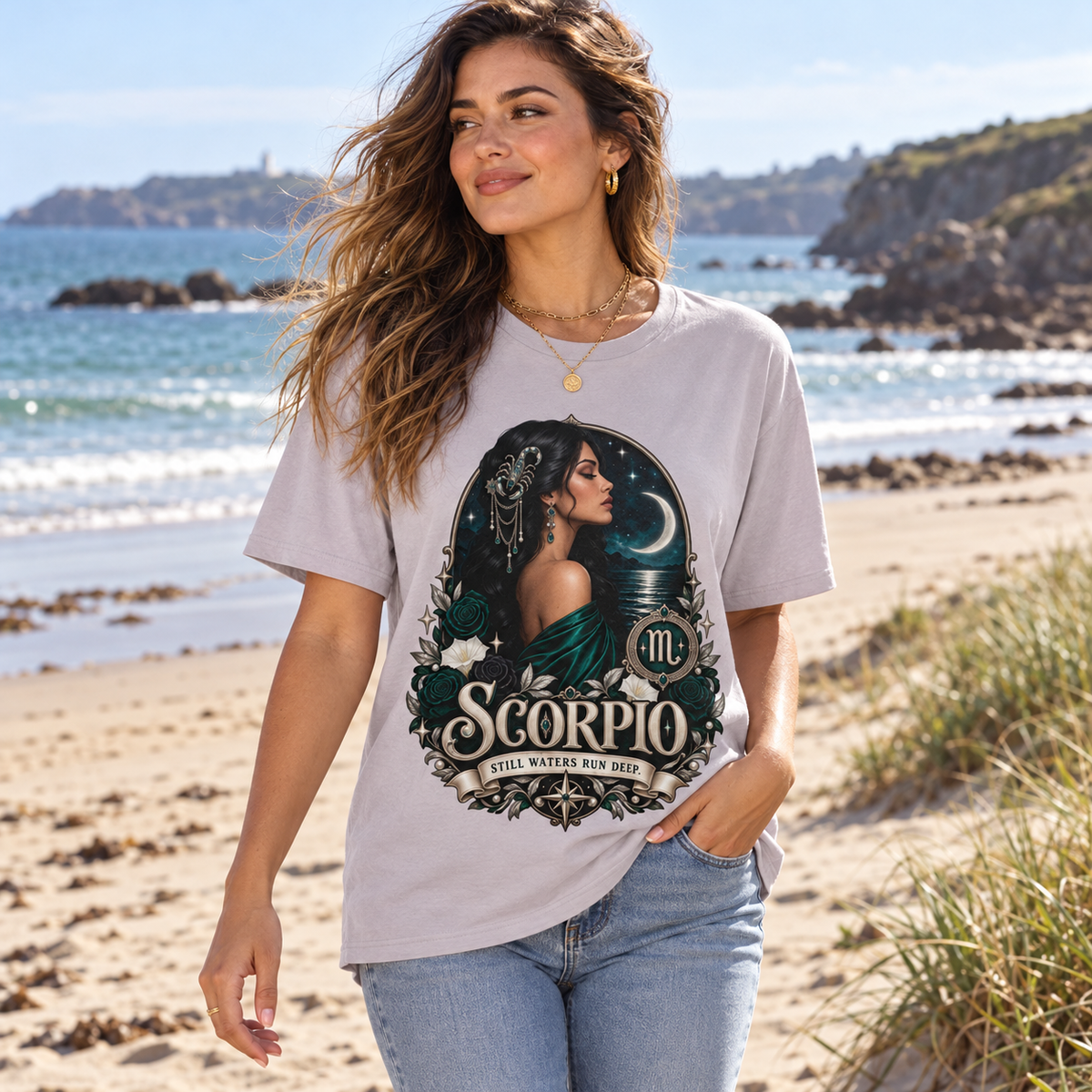 Scorpio Still Waters Run Deep Women's T-Shirt – Dark in Ice Grey, model walking on a sandy Channel Islands beach with dunes and sea