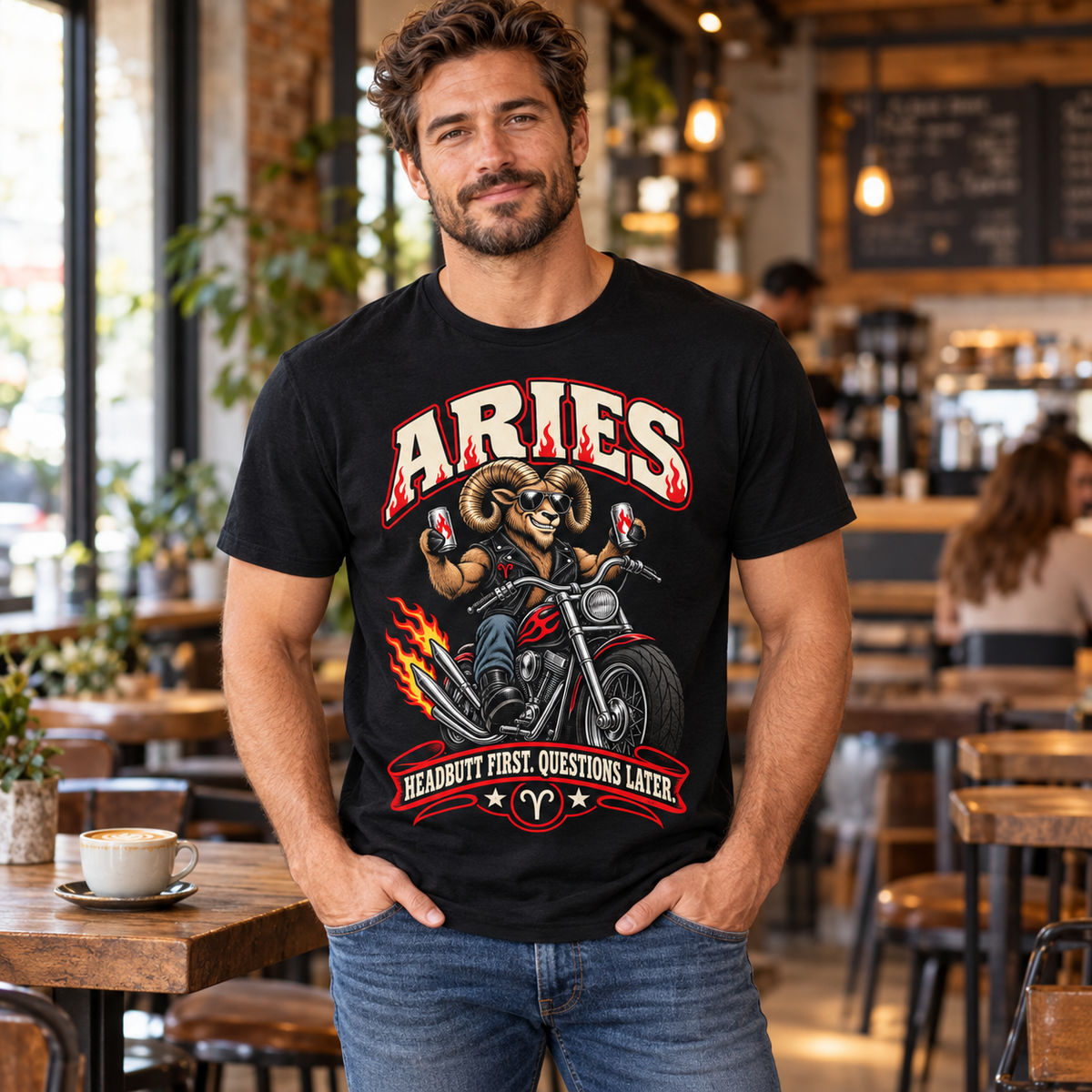 Aries Headbutt First Questions Later Men's T-Shirt, model wearing the original design in a cosy stylish coffee shop indoors.