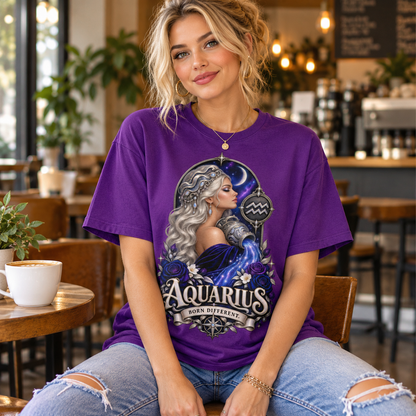 Aquarius Born Different Women's T-Shirt – Dark Colours, model wearing the original design in a cosy stylish coffee shop indoors.