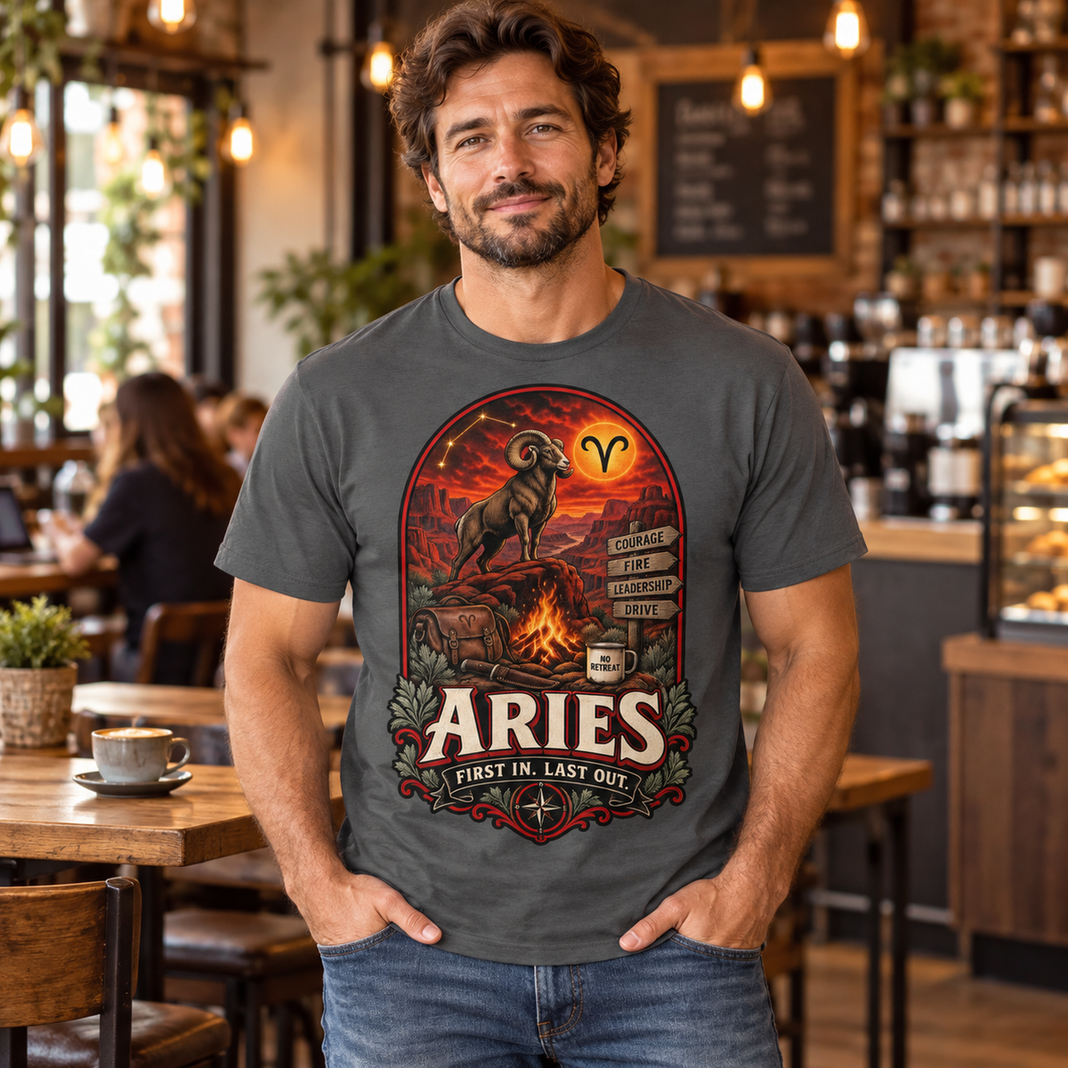 Aries First In Last Out Men's T-Shirt, model wearing the original design in a cosy stylish coffee shop indoors.