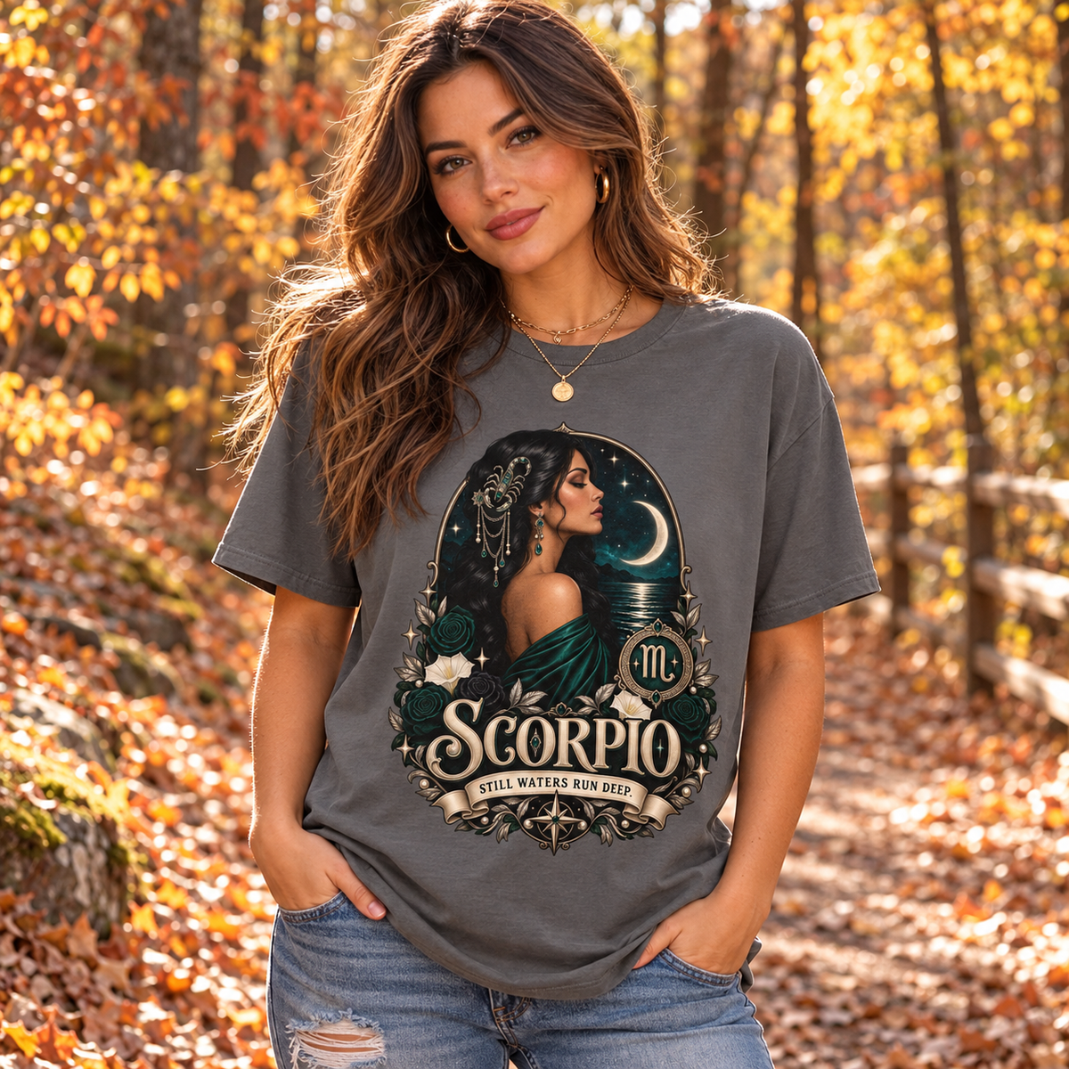 Scorpio Still Waters Run Deep Women's T-Shirt – Dark in Charcoal, model on an autumn woodland path with golden foliage
