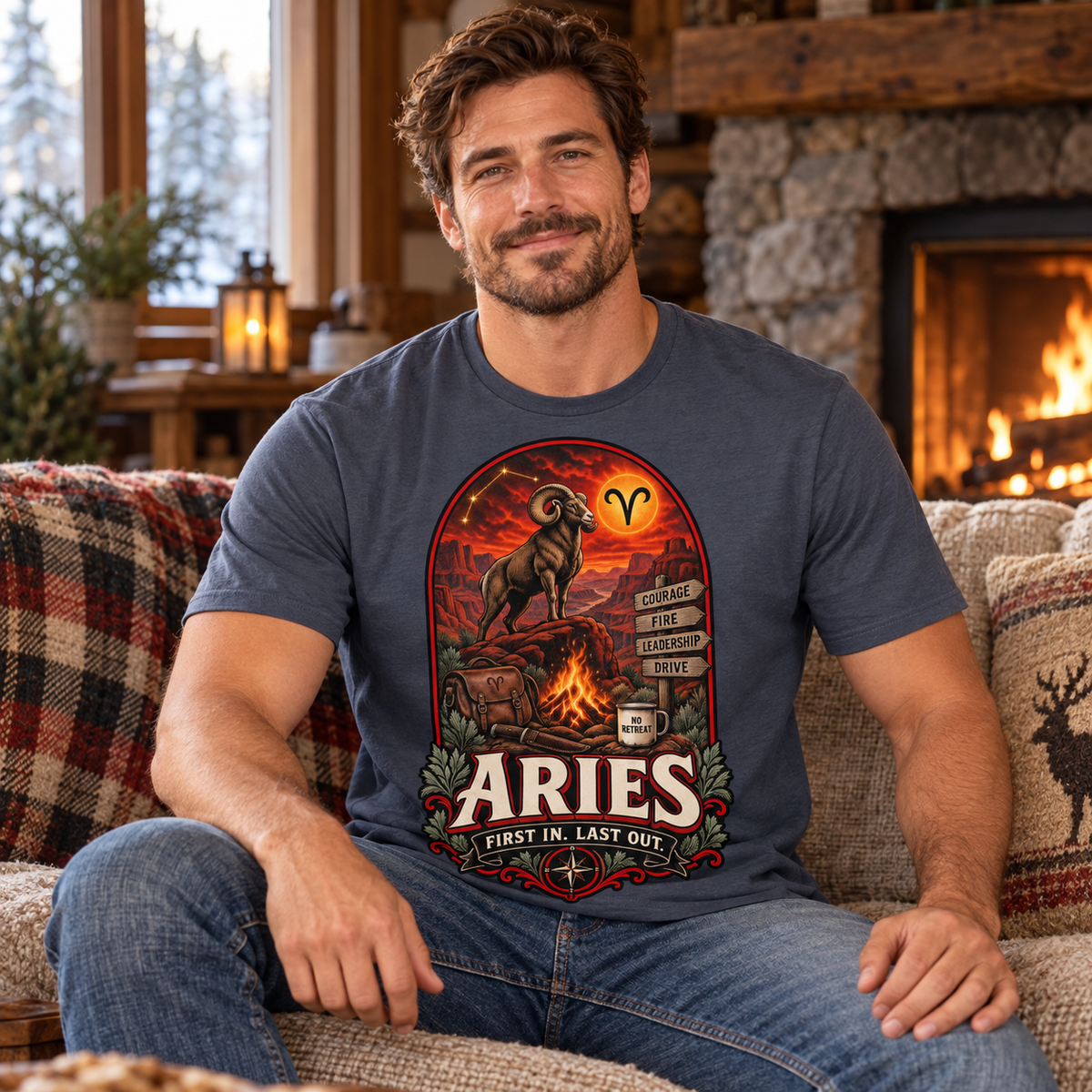 Aries First In Last Out Men's T-Shirt, model wearing the original design in a seated comfortably on a cottage sofa beside a fireplace indoors.