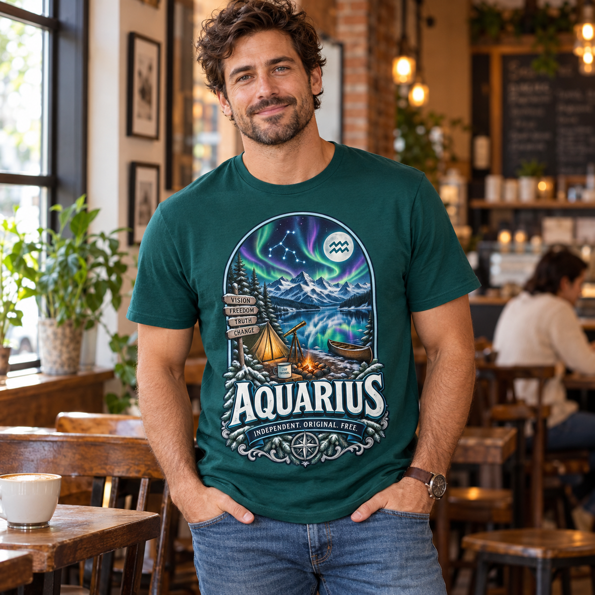Aquarius Independent Original Free Men's T-Shirt, model wearing the original design in a cosy stylish coffee shop indoors.