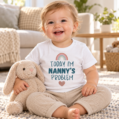 Baby wearing White Today I'm Nanny's Problem rainbow T-shirt