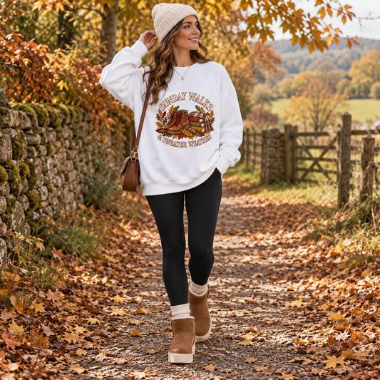 Arctic White Sunday Walks sweatshirt outdoors with black leggings, sheepskin boots and accessories
